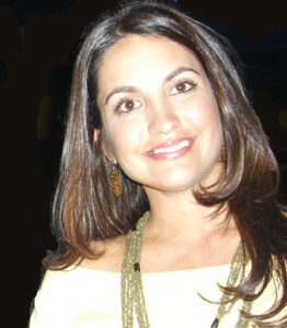 A woman wearing a yellow top.